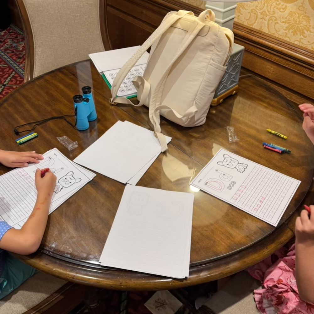 Round table with backpack and printed activities